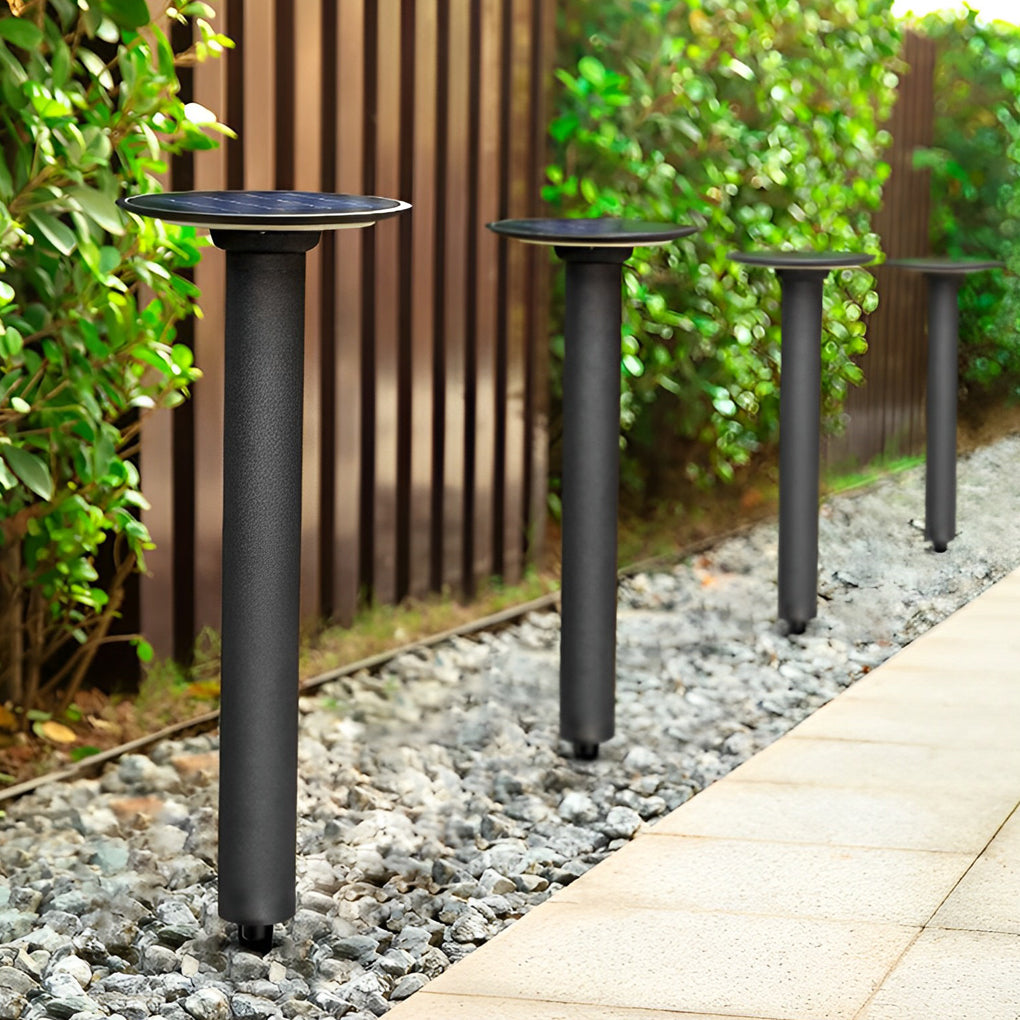 Decorative solar path lights arranged beside a fence and gravel path, guiding movement with subtle outdoor lighting.
