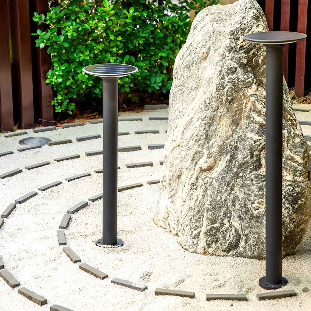 Decorative solar path lights surrounding a stone feature in a zen-style garden, creating a calm nighttime atmosphere.