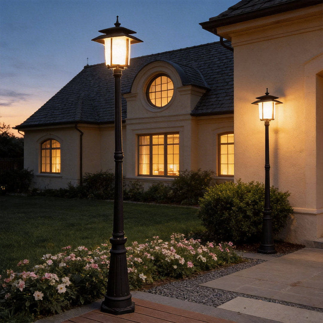 Decorative street light with a classic design, illuminating a driveway in front of a luxury house.
