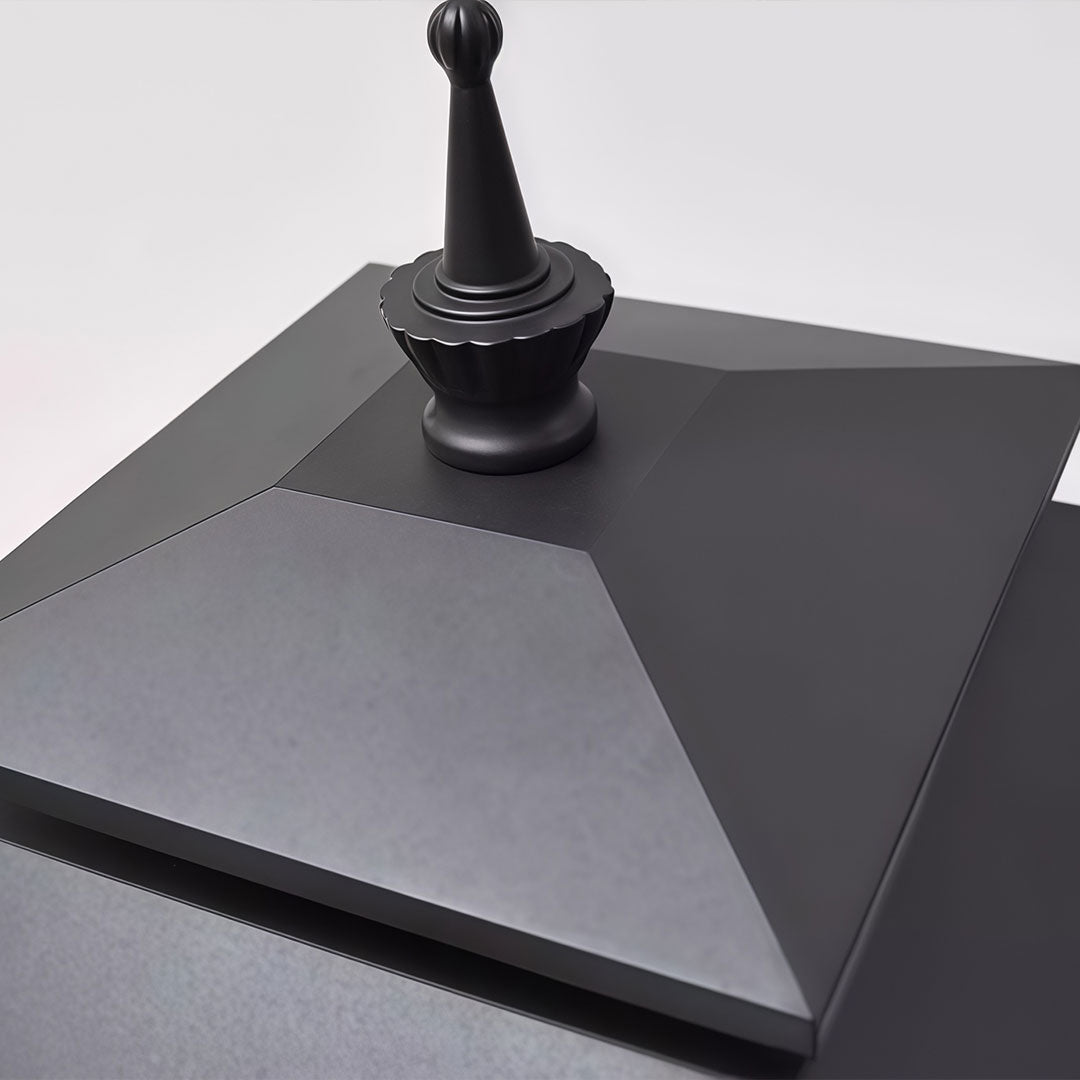 Decorative street light with a classic design, providing soft illumination on a paved walkway.