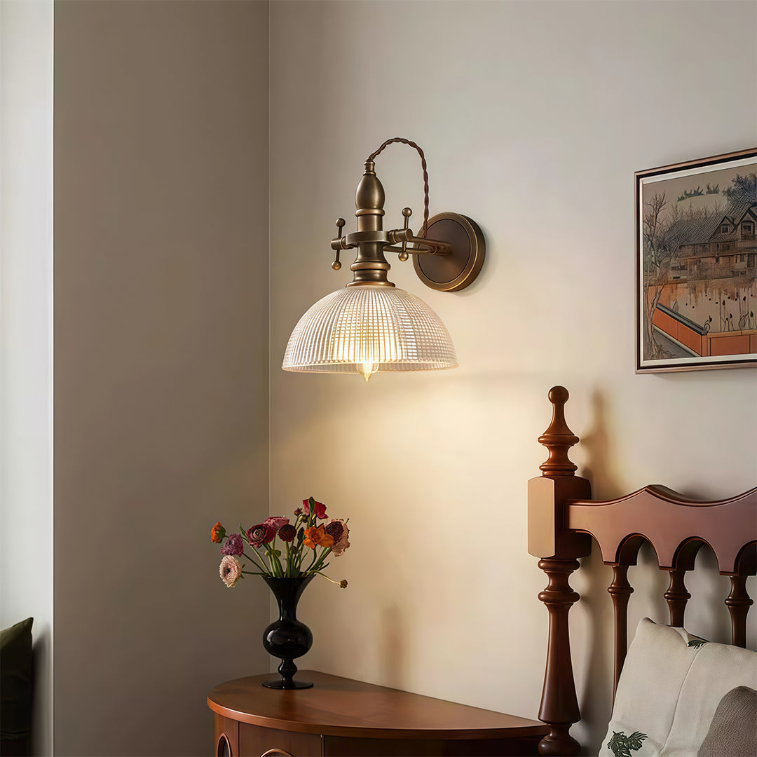Designer indoor wall mount lights featuring glass shade chandelier aesthetic creating warm accent lighting in hallway with decorative vase.