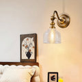 Designer LED wall light lamp featuring glass shade chandelier aesthetic illuminating entryway with warm ambient glow.