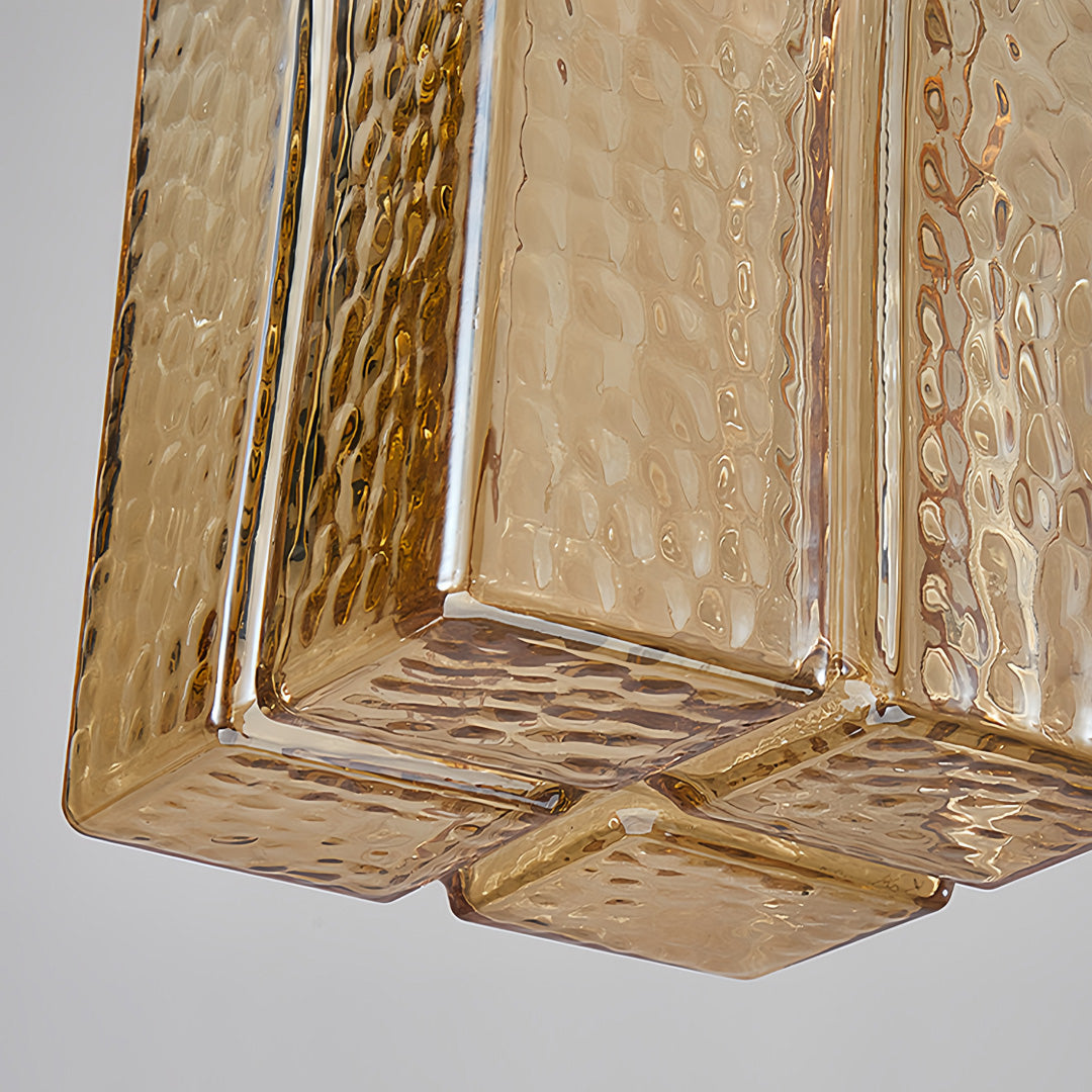 Designer square glass pendant lights in modern kitchen with clean lines and sophisticated interior styling.
