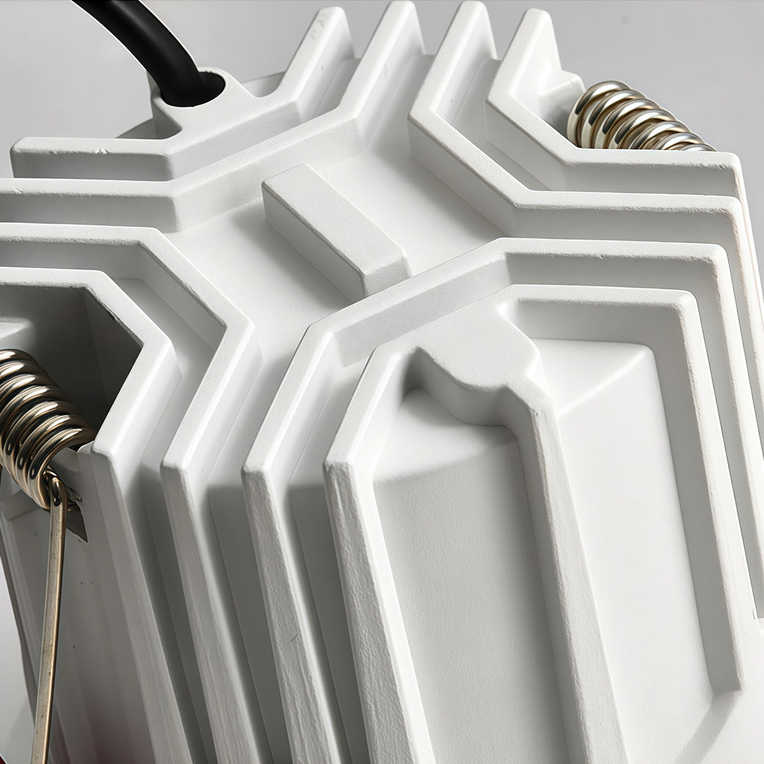 Close-up of the die-cast aluminum heat sink and spring mechanism on a premium LED downlight recessed light.