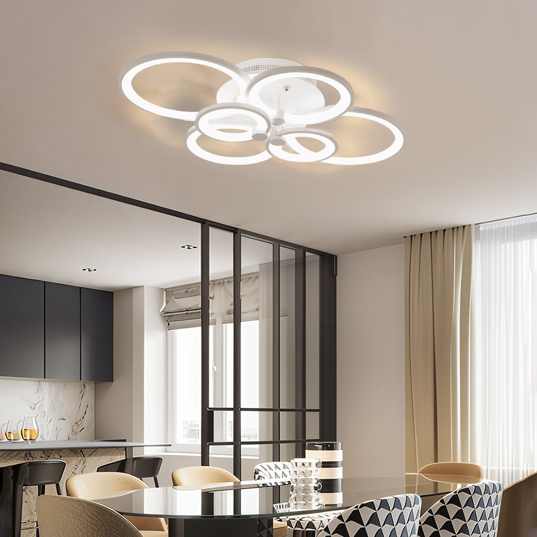 Open plan dining area illuminated by contemporary LED multi ring ceiling lights with clean lines.