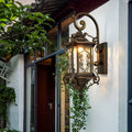 Outdoor wall sconce lights installed beside a wooden door, creating welcoming ambiance.