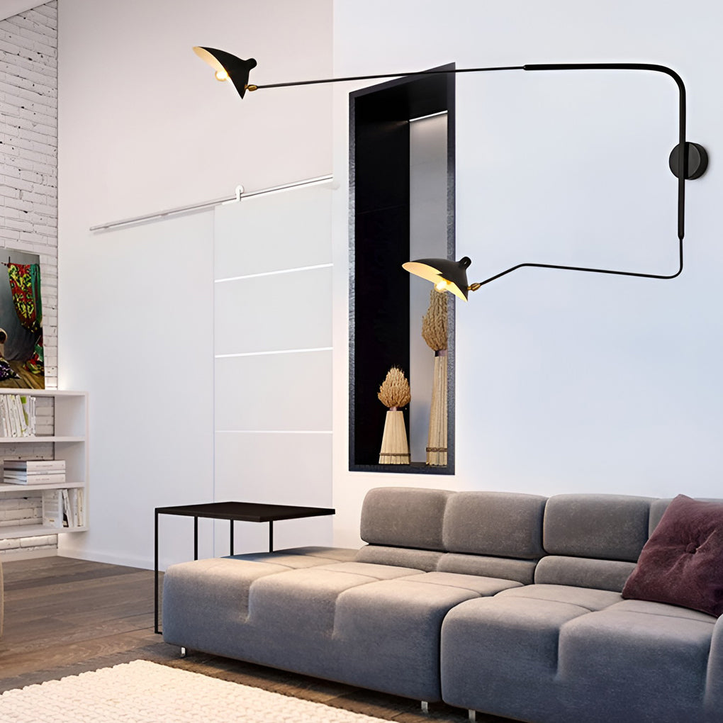 Double arm wall sconce with extended arms above a sofa, offering flexible task lighting in a modern living room.