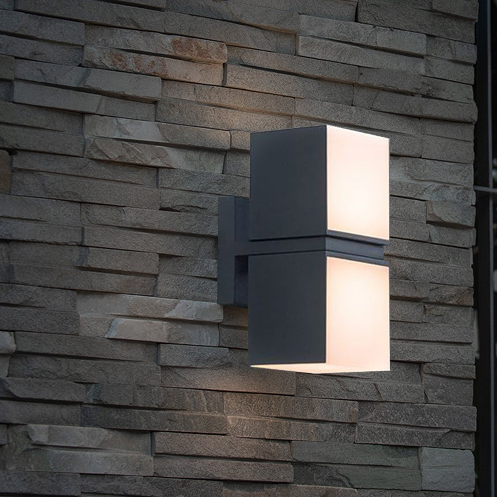 Double head wall light mounted on a textured stone wall, highlighting modern architectural details with warm illumination.