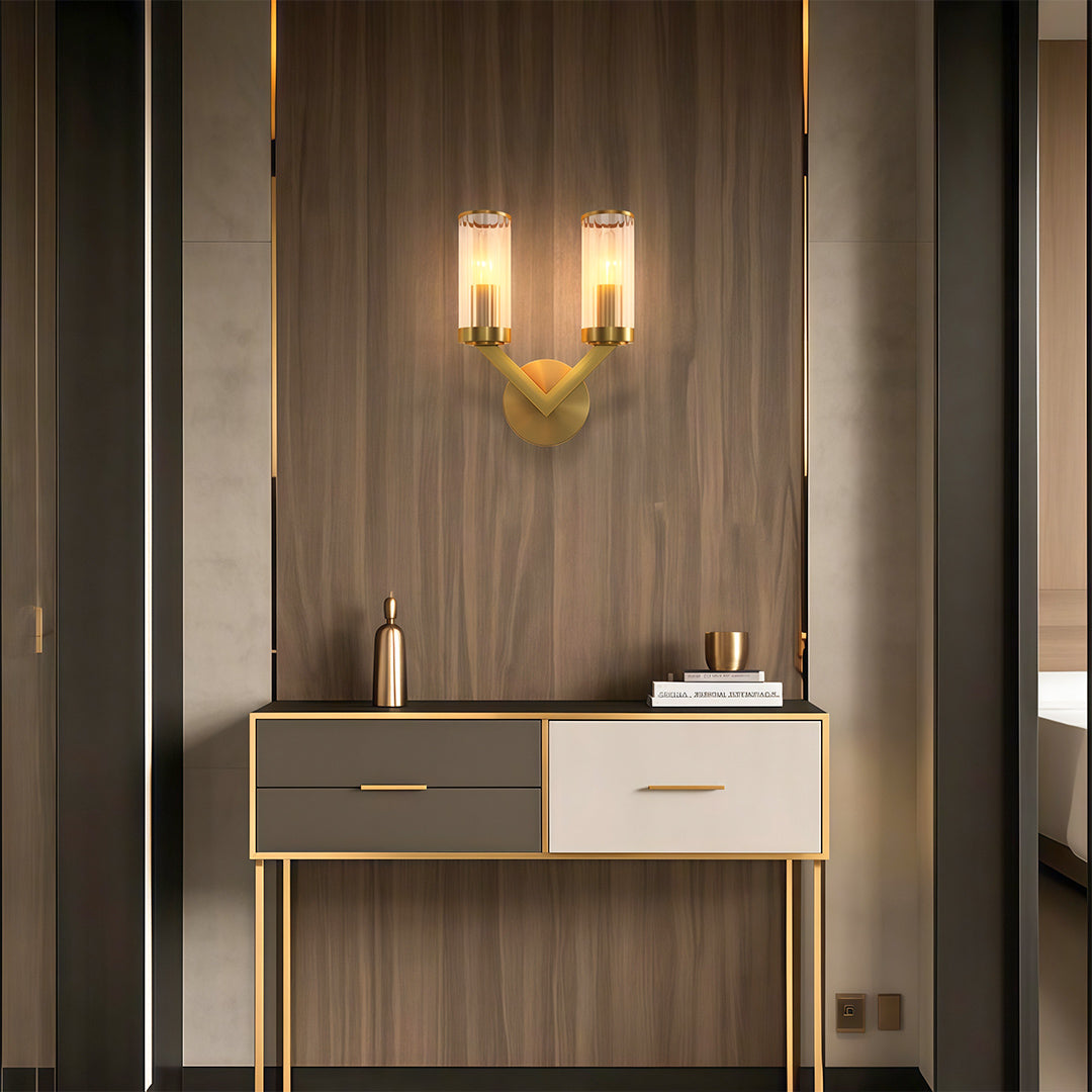 Double sconce wall light creating warm ambiance in contemporary entryway with console table.