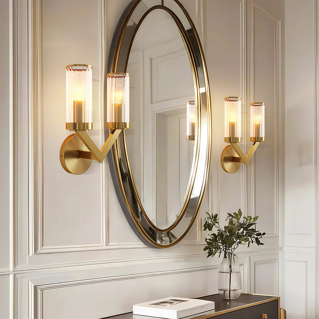 Modern luxury chandeliers style double sconce wall light beside oval mirror above marble console.