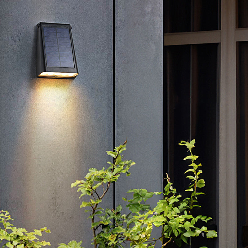Down light wall sconce mounted on an outdoor garden wall.