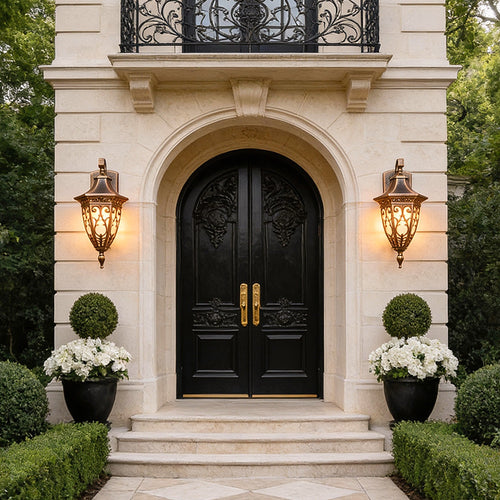 Elegant antique art deco wall sconces illuminating a grand entrance, featuring ornate bronze frames and soft ambient lighting.