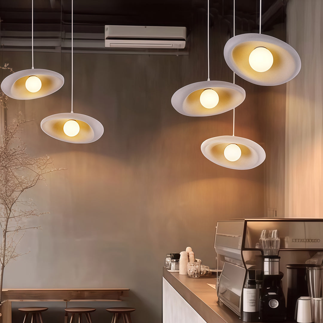 Elegant Japanese pendant lights with glass shade chandelier design in clustered arrangement illuminating modern kitchen space.
