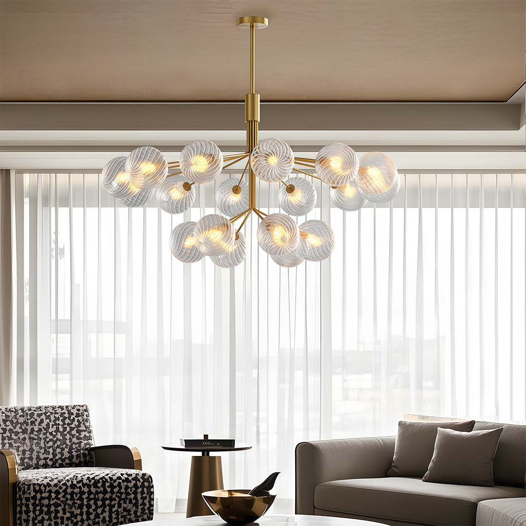 Elegant luxury modern chandeliers with gold accents, illuminating a stylish living room with large windows.