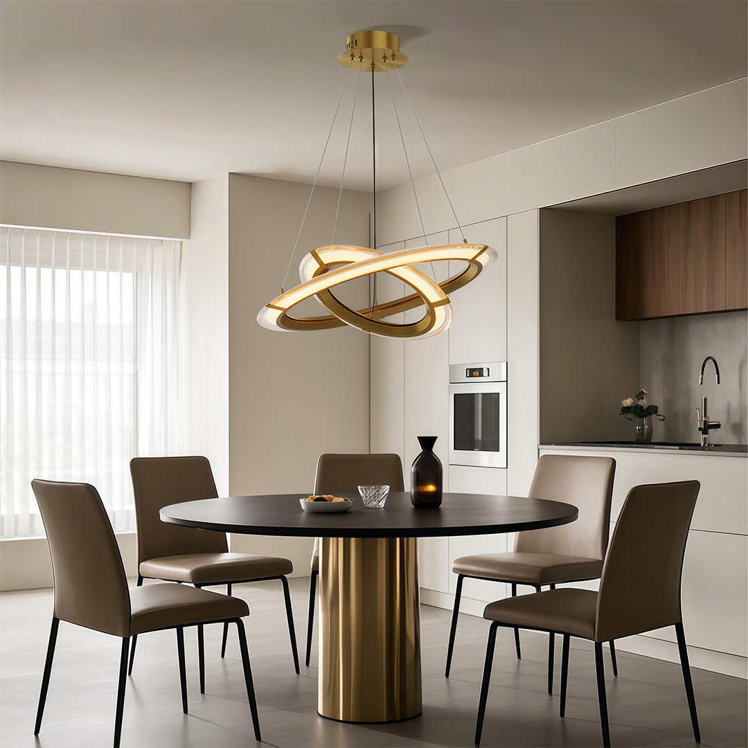 Elegant modern round chandelier illuminating a dining area with a minimalist design and wooden accents.