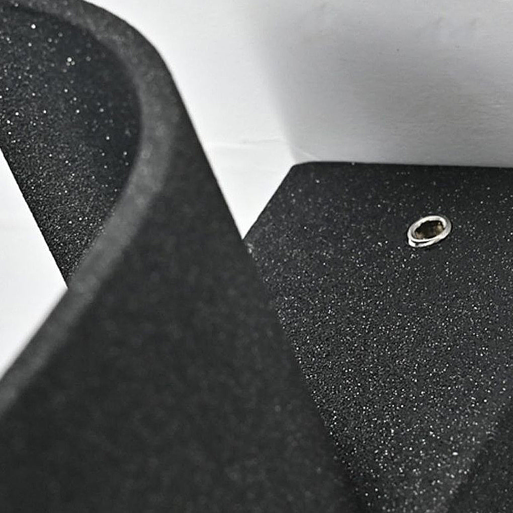 Macro detail of exterior down wall lights showing textured black metal finish and mounting screw.
