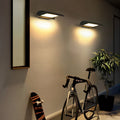 Modern exterior down wall lights installed on outdoor wall providing soft downward illumination near bicycles.