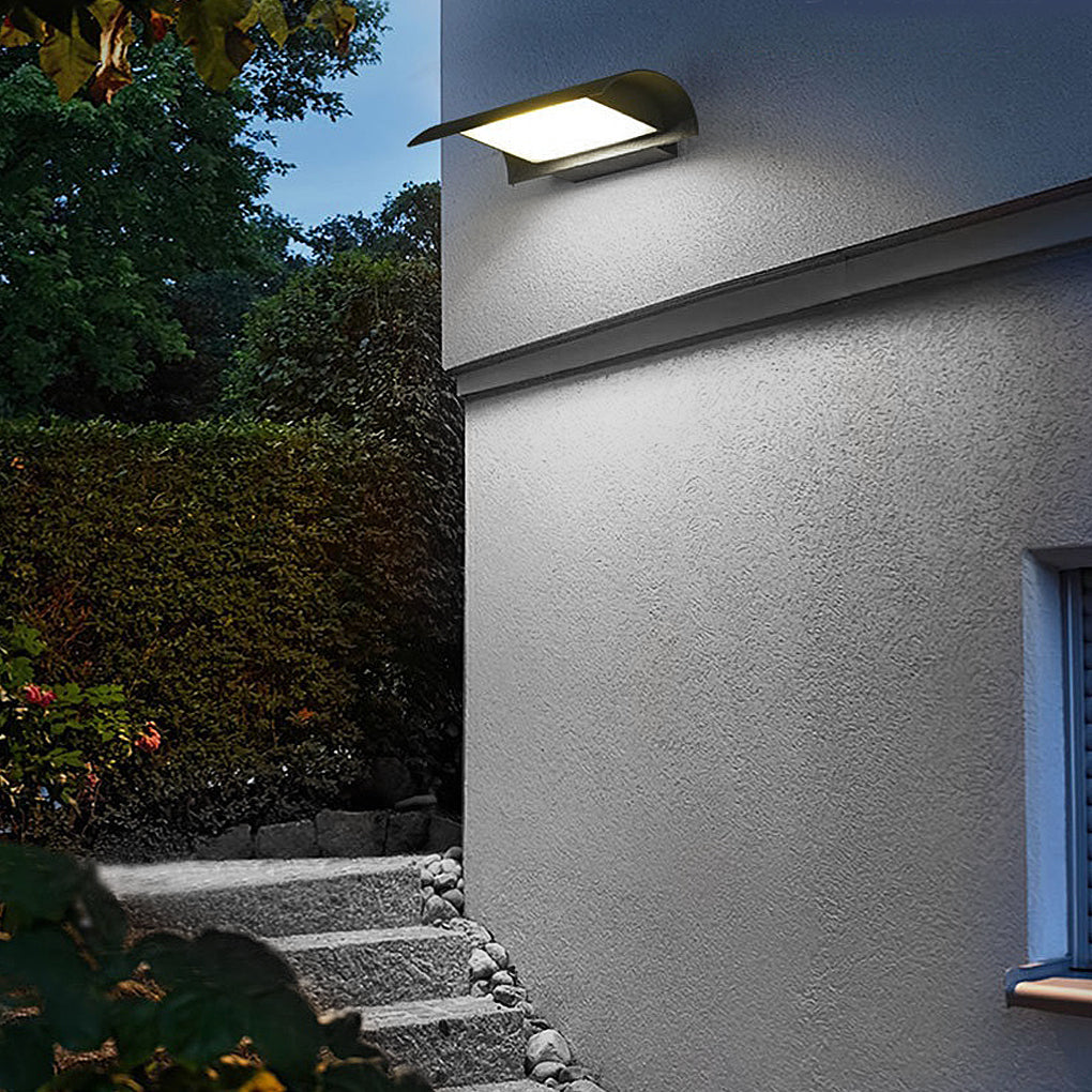 Exterior down wall lights mounted on textured exterior wall illuminating pathway steps at night.