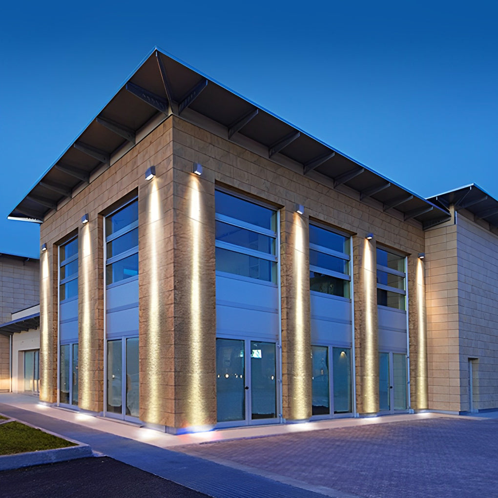 Facade spot lights illuminating tall columns of a contemporary commercial building, enhancing vertical architectural lines.