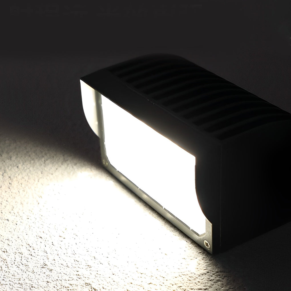 Facade spot lights product image showing a compact rectangular outdoor light casting a focused beam on concrete.