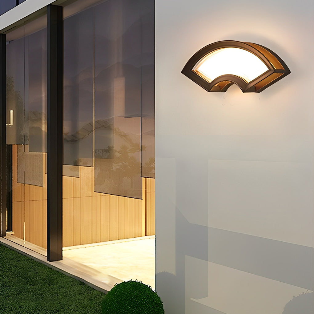 Fan shaped wall sconce with a black frame, enhancing a modern interior wall.