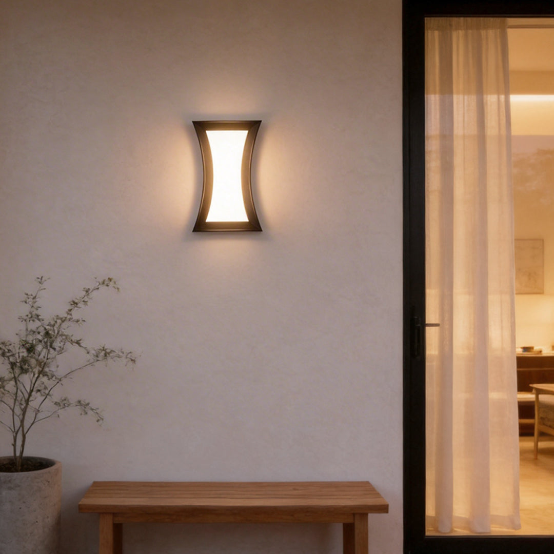 Fan shaped wall sconce with a close-up of its glowing light and curved design.