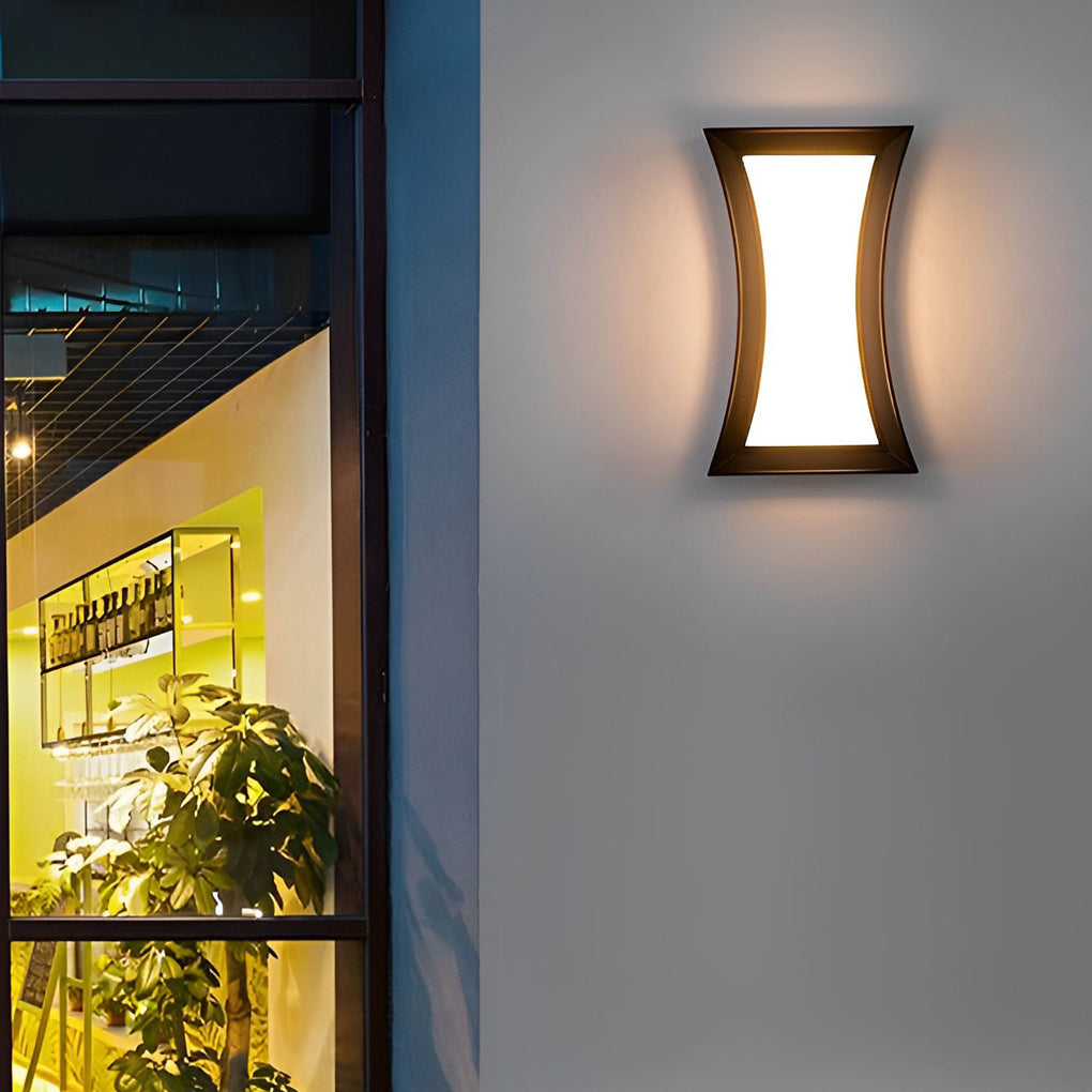 Fan shaped wall sconce with a minimalist design, providing warm light near a window.
