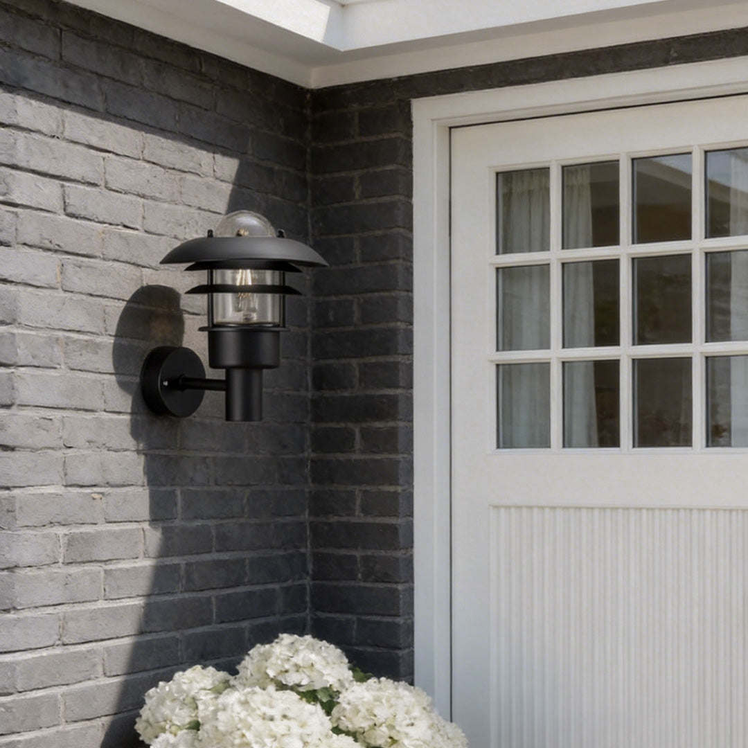 Farmhouse outdoor sconce with a vintage design, illuminating a wooden front door.