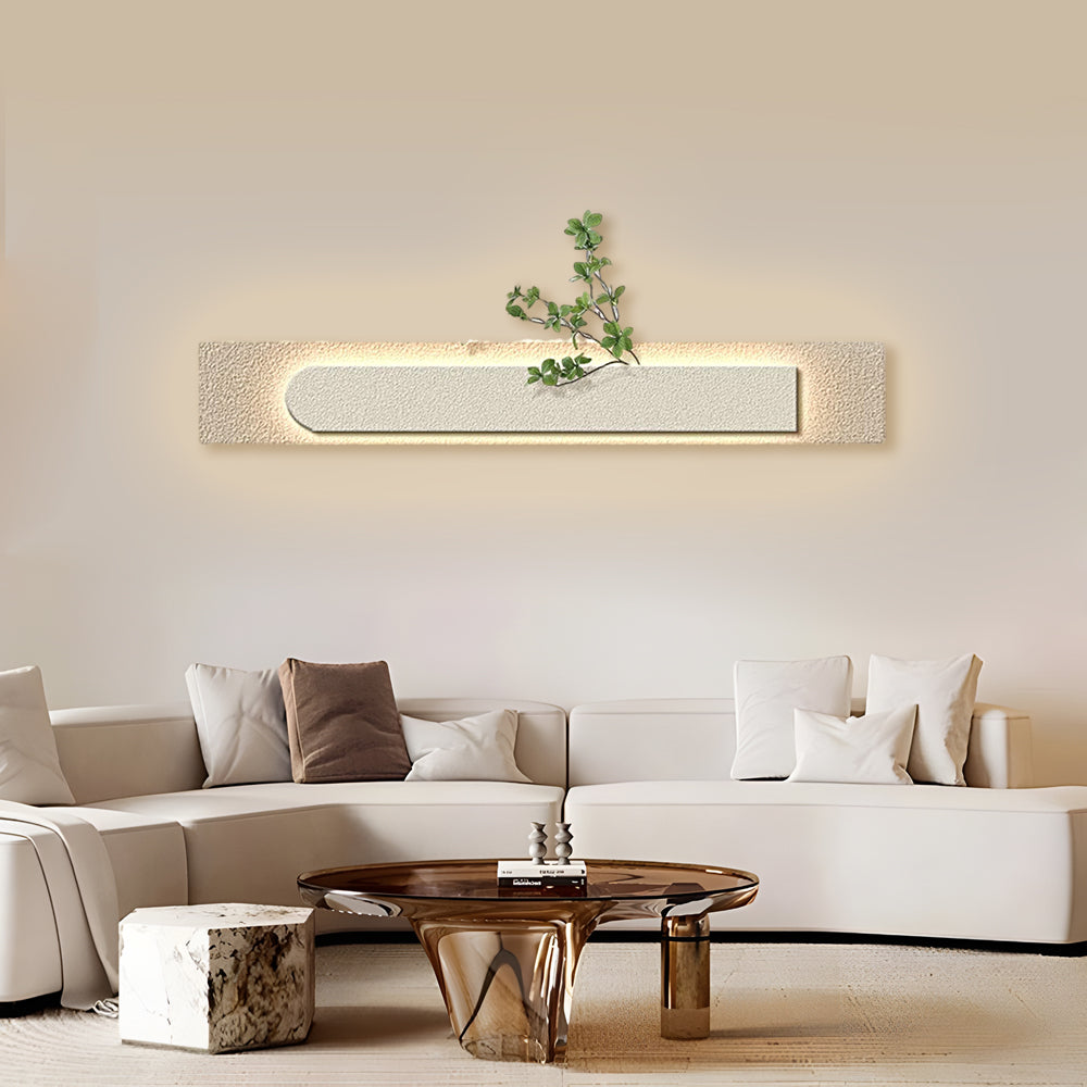 Faux sandstone wall light with a close-up of the sandstone texture and greenery.