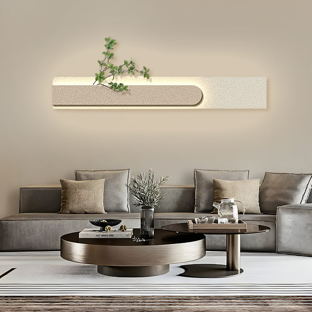 Faux sandstone wall light illuminating a modern living room with warm, ambient glow.