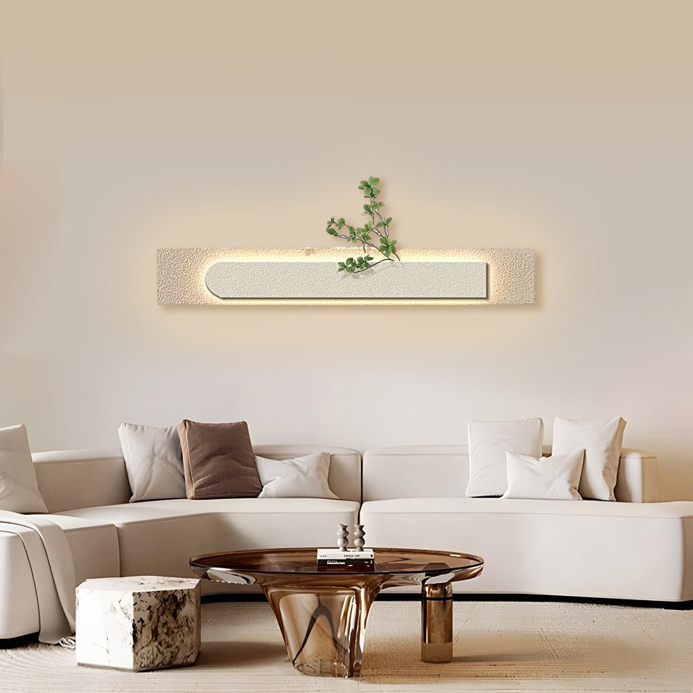 Faux sandstone wall light enhancing a modern sofa area with built-in planter.