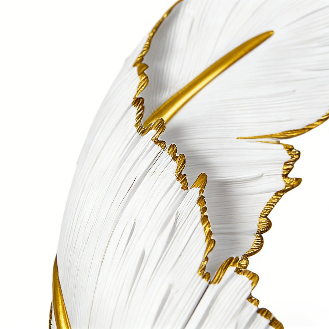 Feather LED wall lamp with a golden finish, providing soft illumination in a living room.