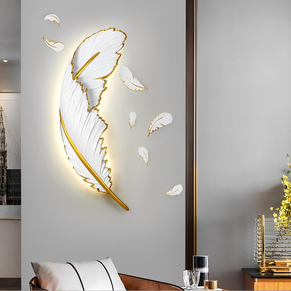 Feather LED wall lamp with a golden finish, providing warm light above a bed.