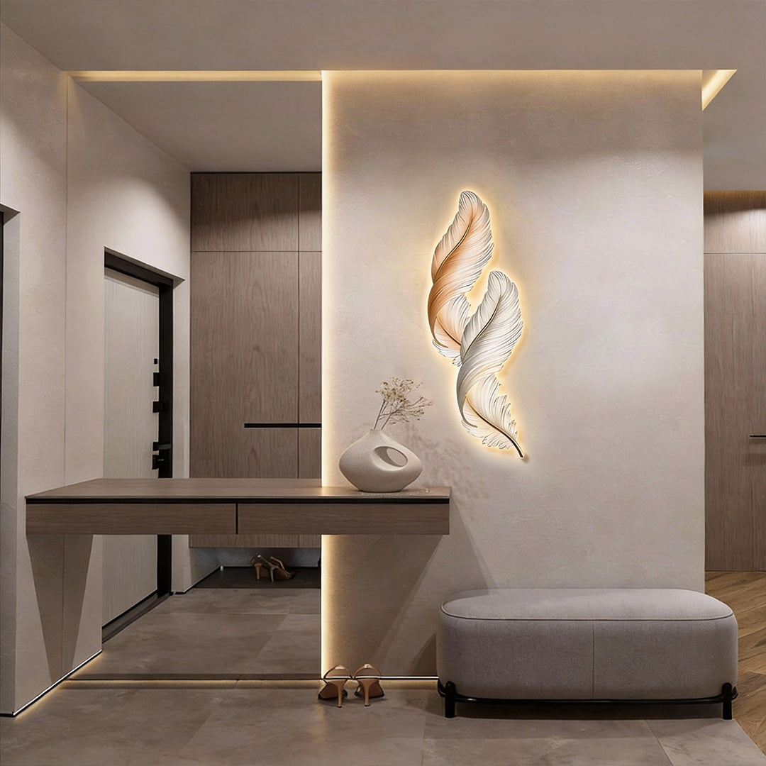 Elegant feather wall decor light displayed above a console table, creating a sculptural focal point in a hallway.