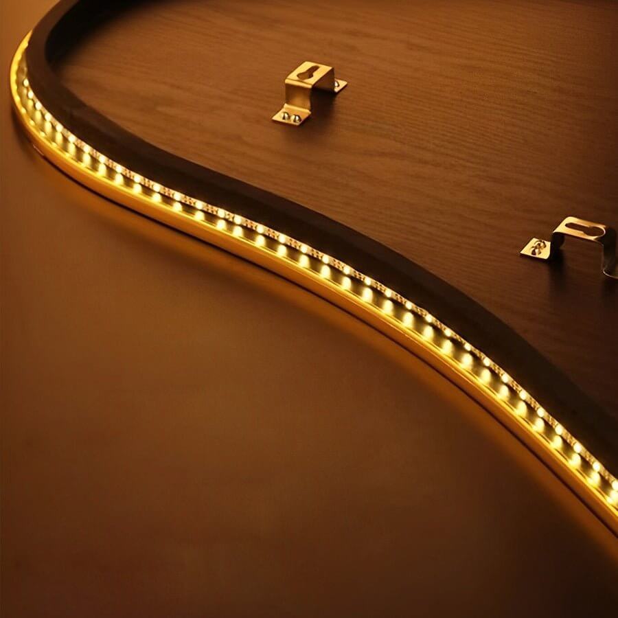 Close-up detail of feather wall decor light LED strip, showing warm light diffusion and curved design.