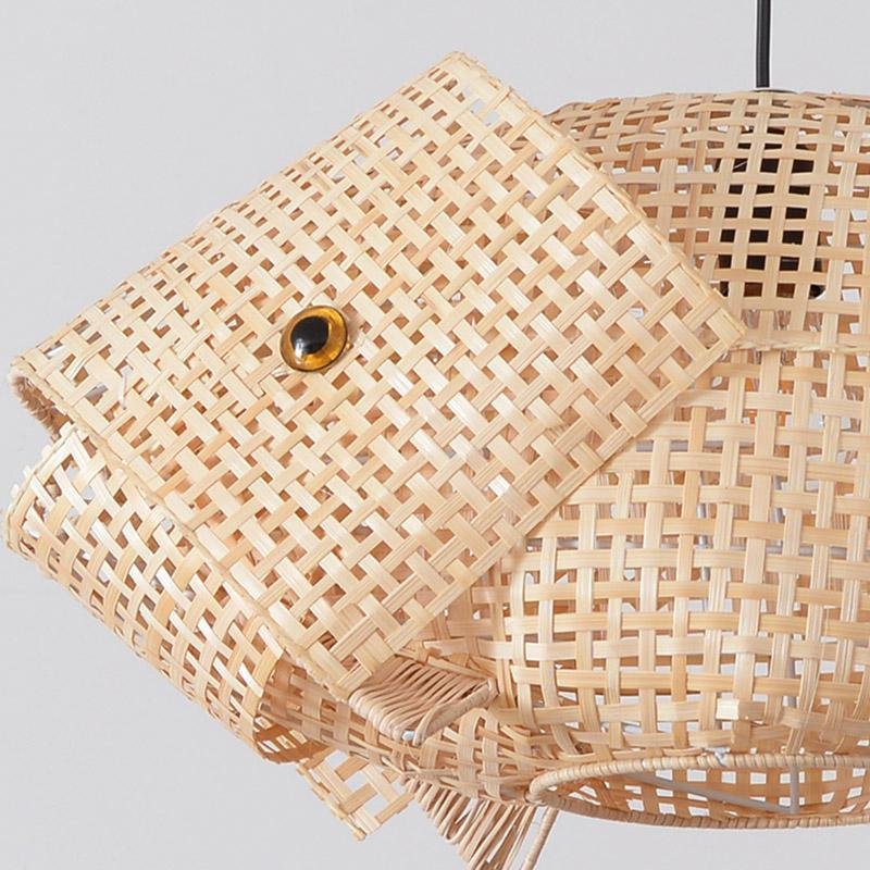Fish pendant light with a rattan finish, providing soft illumination in a stylish room.