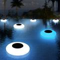 Floating pond lamp glowing on water surface at night
