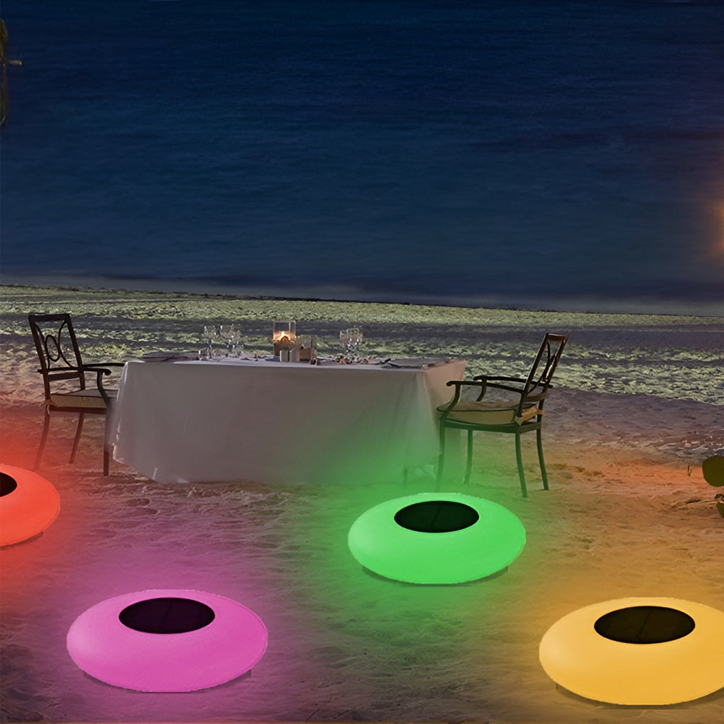 Floating pond lamps illuminating outdoor patio at night