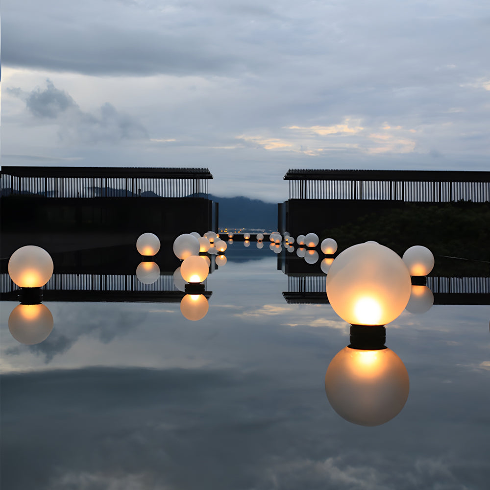Silver Metal Table Lamp floating round lights arranged on water feature providing serene illumination in luxury outdoor space