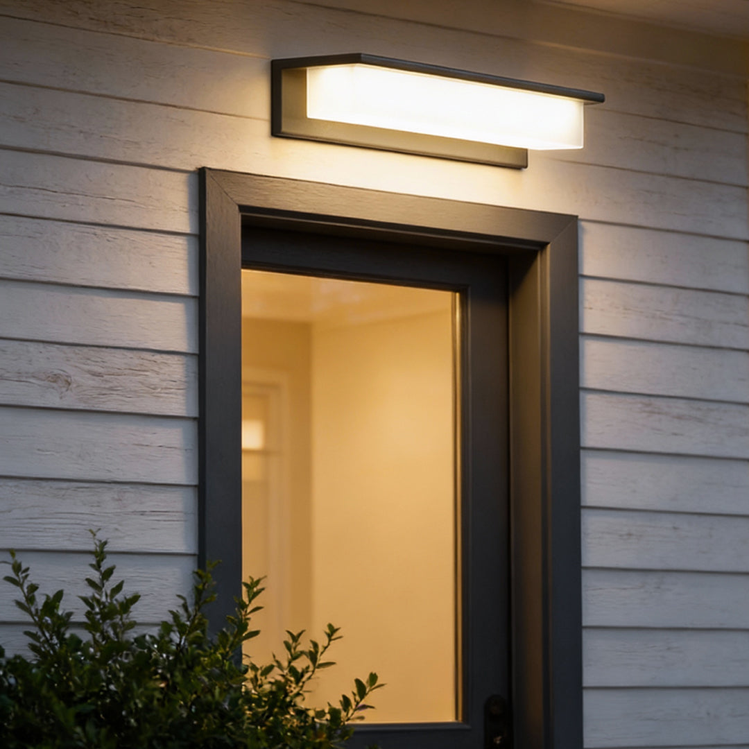 Front porch light fixtures beside entrance door with ambient light.