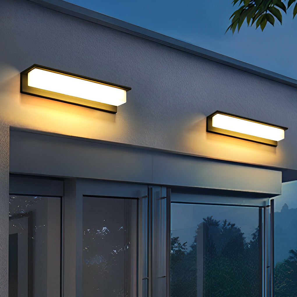 Front porch light fixtures illuminating modern house exterior with warm glow.