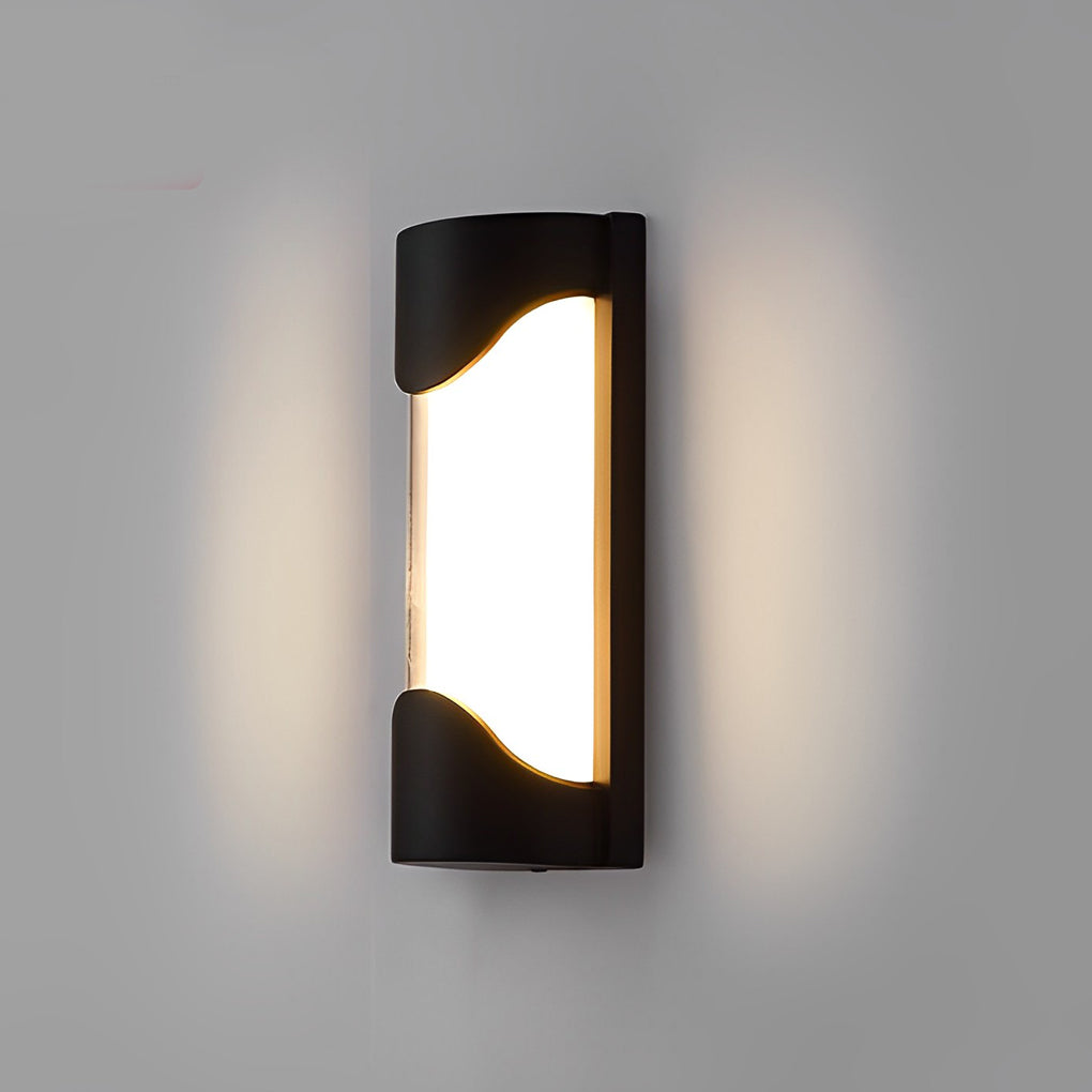 Black outdoor wall light with frosted glass on wooden wall near pathway.