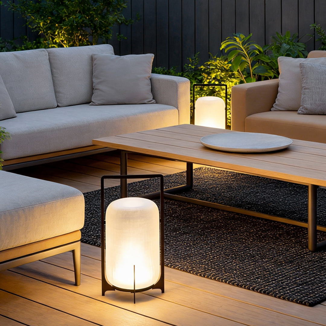 Outdoor modern handle lantern with frosted glass shade illuminating patio sofa and coffee table.