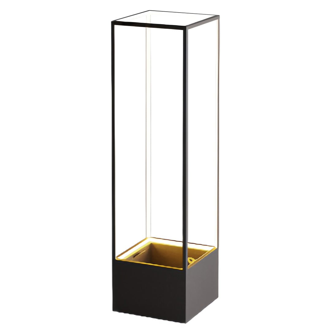 Full-height product shot of the square floor lamps, emphasizing the clear glass enclosure and the dark, textured base material.