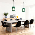 Fun pendant lights made of modern green felt with a ribbed pattern, illuminating a stylish dining space with black chairs.