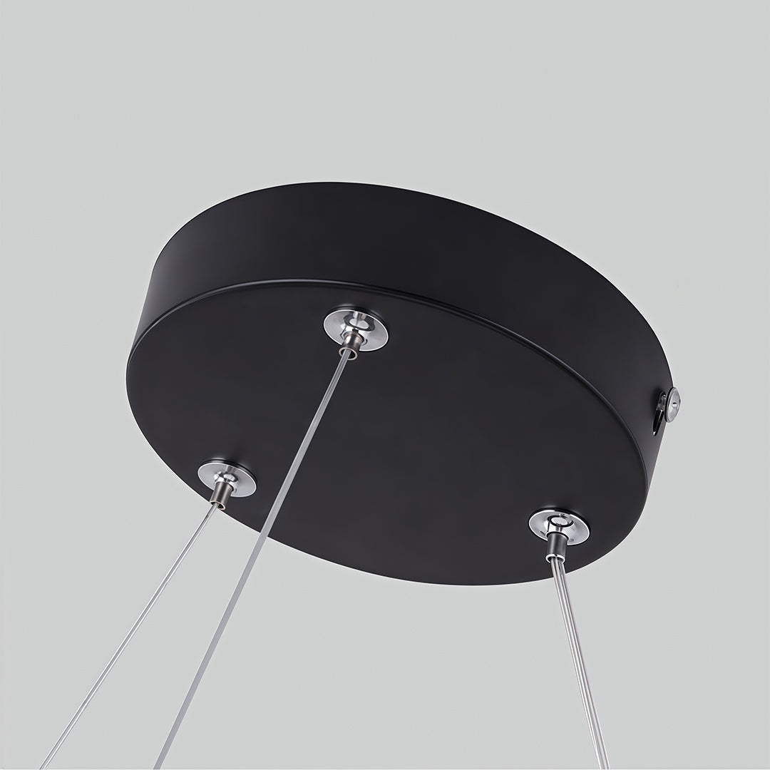 A unique modern geometric chandelier suspended in a gallery space, adding a contemporary feel.