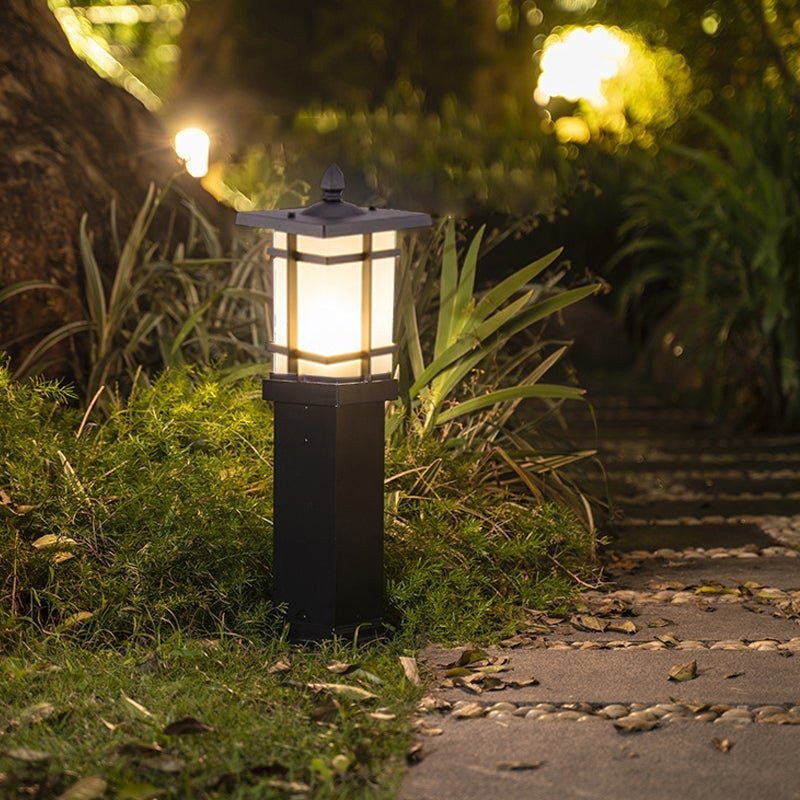 Garden bollard lighting illuminating a stone pathway in a lush garden.