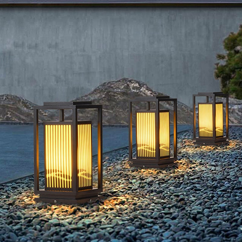 Garden bollards lights with a black frame, providing elegant lighting near steps.