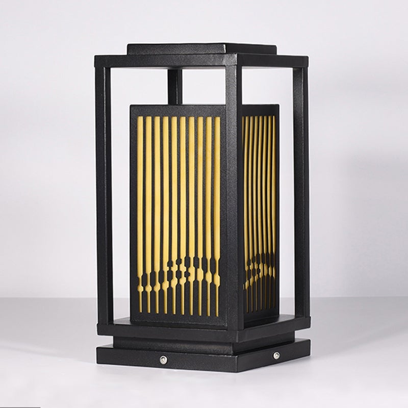 Garden bollards lights with a black frame, providing soft light near a water feature.