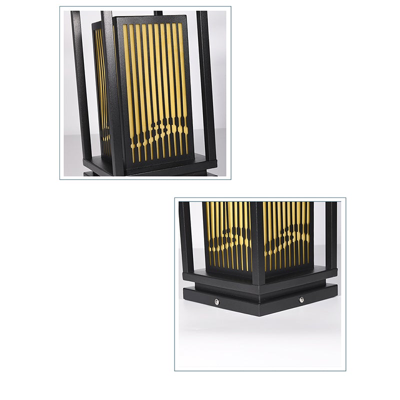 Garden bollards lights with a black finish, providing warm illumination in a garden.